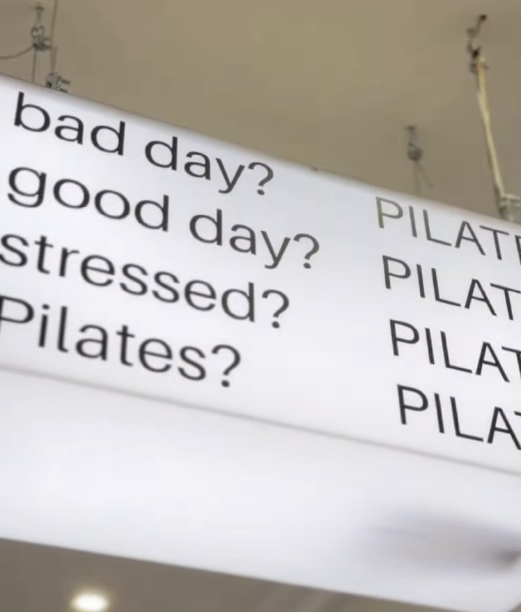 Cartel del estudio con la pregunta 'Pilates?' junto a mensajes sobre bienestar